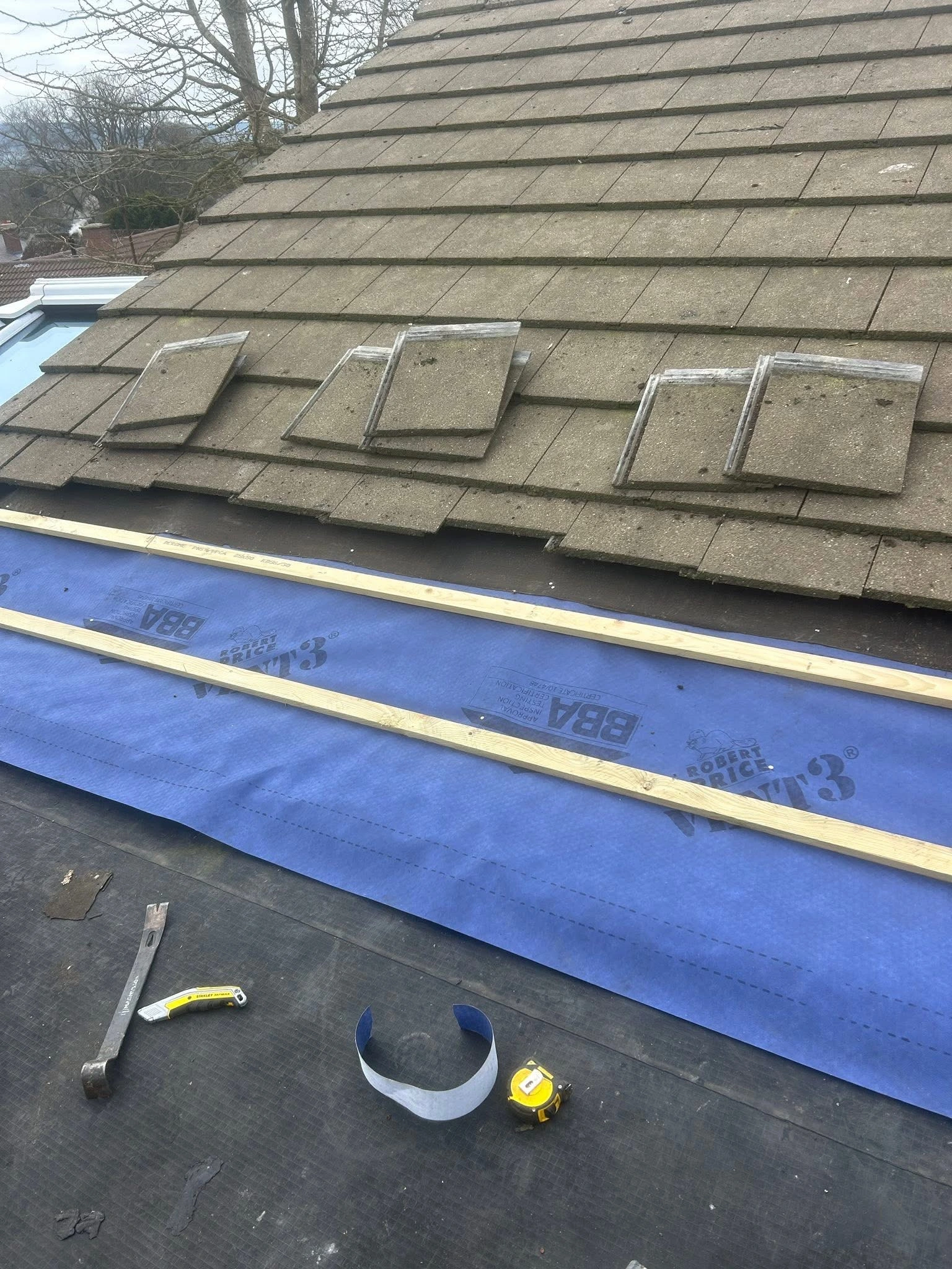 Completed roof and conservatory work on a brick house